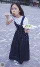 A woman holding a plate of food in her hand.