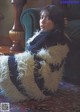 A woman sitting on a couch in a living room.