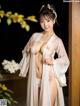 A woman in a white kimono posing for the camera.